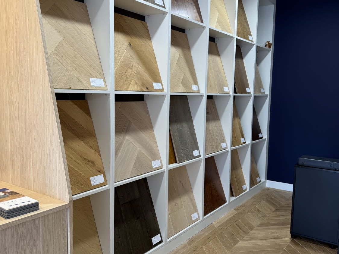 Wall of large-format chevron flooring samples displayed in the Hampton Hill Flooring showroom